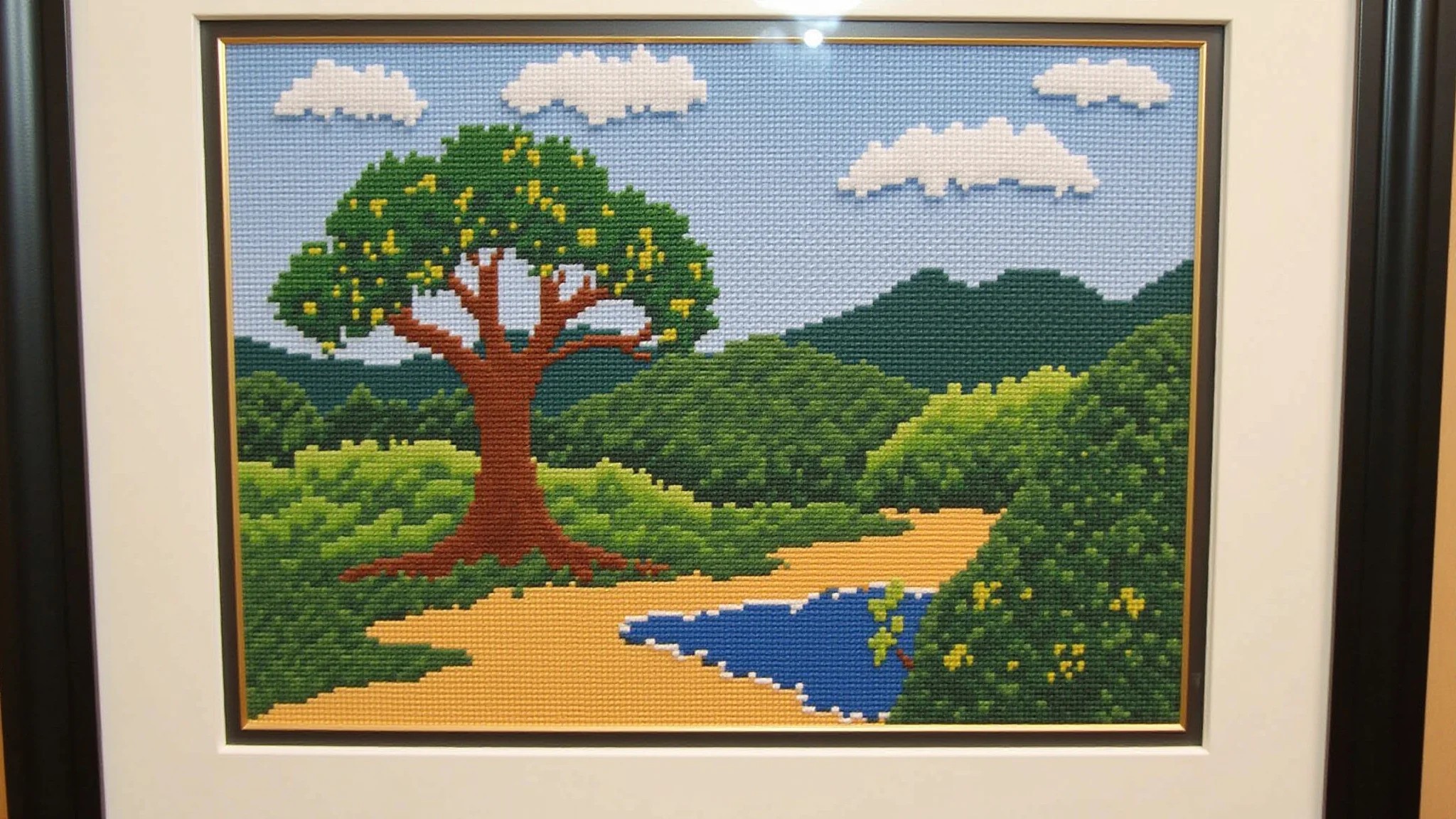 Quadro de ponto cruz finalizado com paisagem brasileira colorida.
