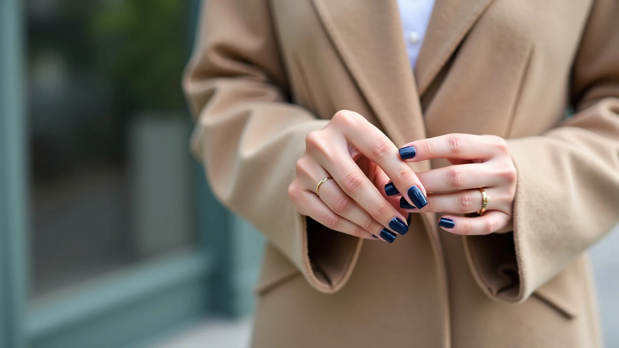 Unhas azul marinho combinando com roupa neutra e elegante.